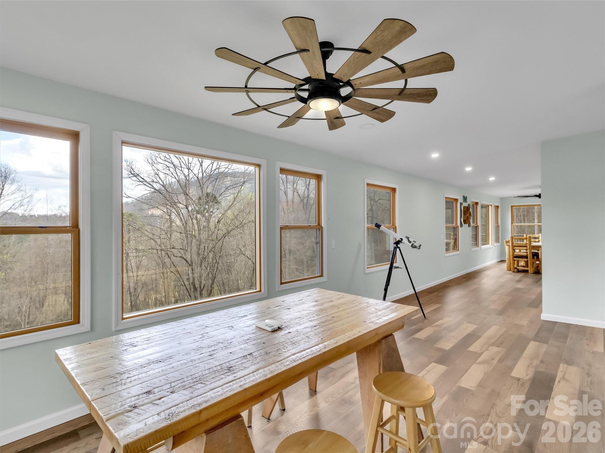 115 Fugitive Run Sylva, NC 28779 - Photo 15 of 47 a view of a livingroom and dining room with wooden floor a chandelier