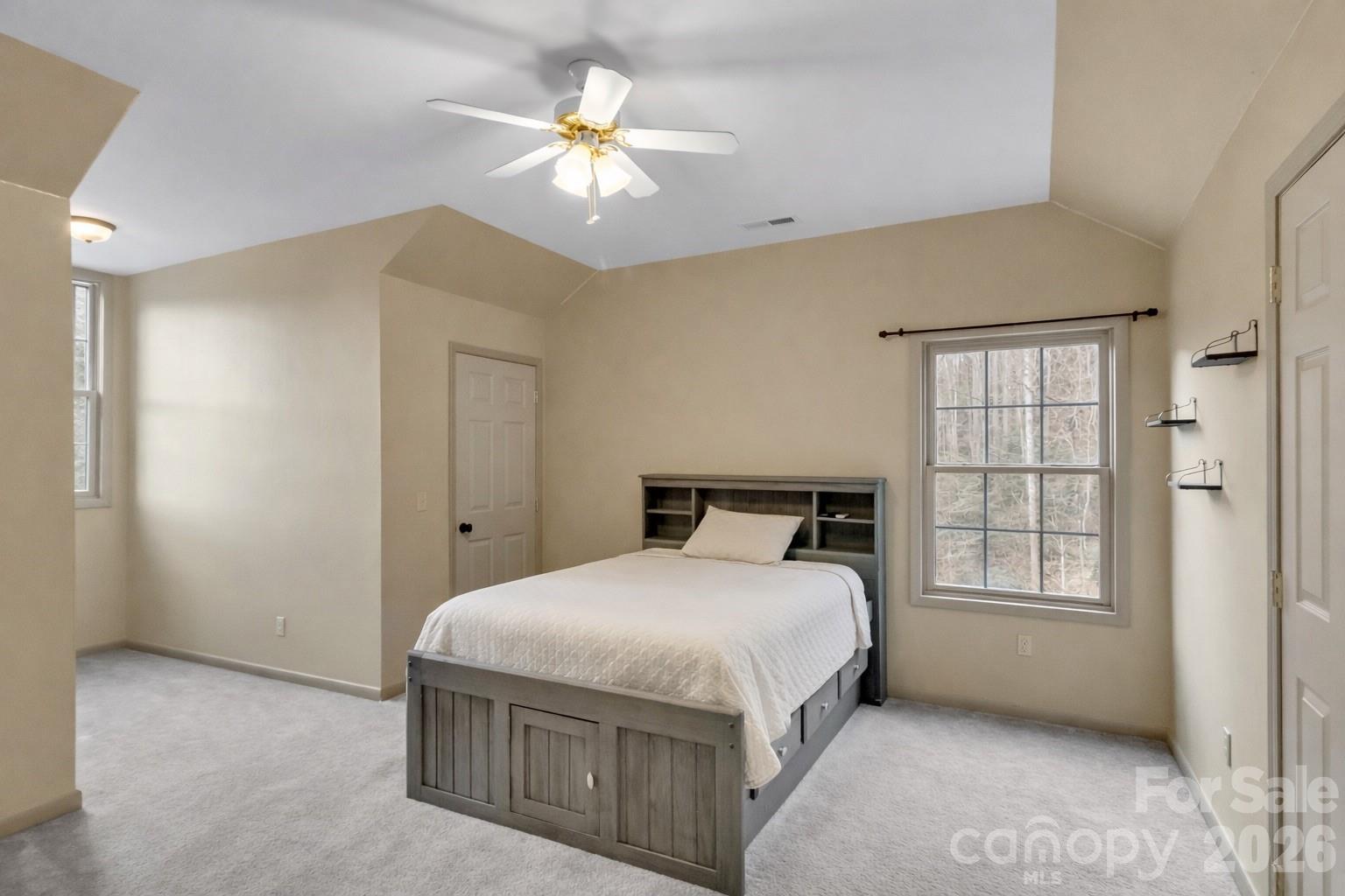 115 Fugitive Run Sylva, NC 28779 - Photo 21 of 47 a bedroom with a bed and a chandelier