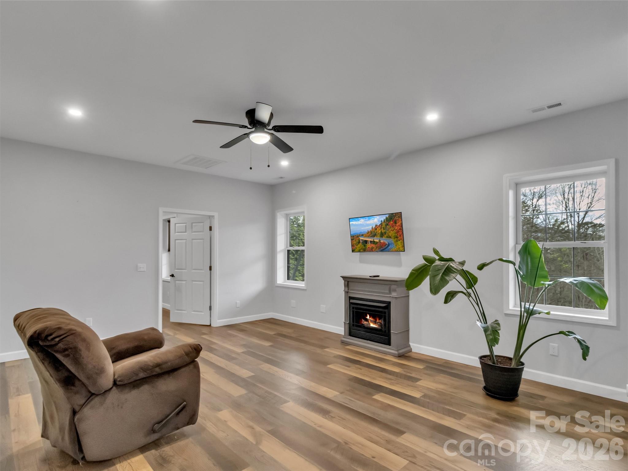 115 Fugitive Run Sylva, NC 28779 - Photo 25 of 47 a living room with furniture a potted plant and a fireplace