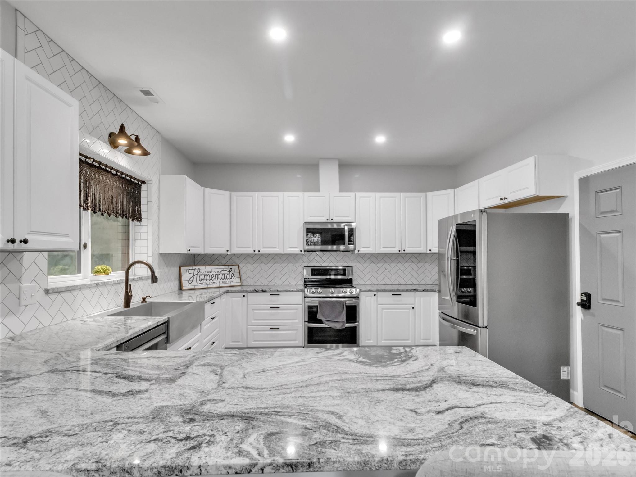 115 Fugitive Run Sylva, NC 28779 - Photo 28 of 47 a kitchen with granite countertop a refrigerator and a sink