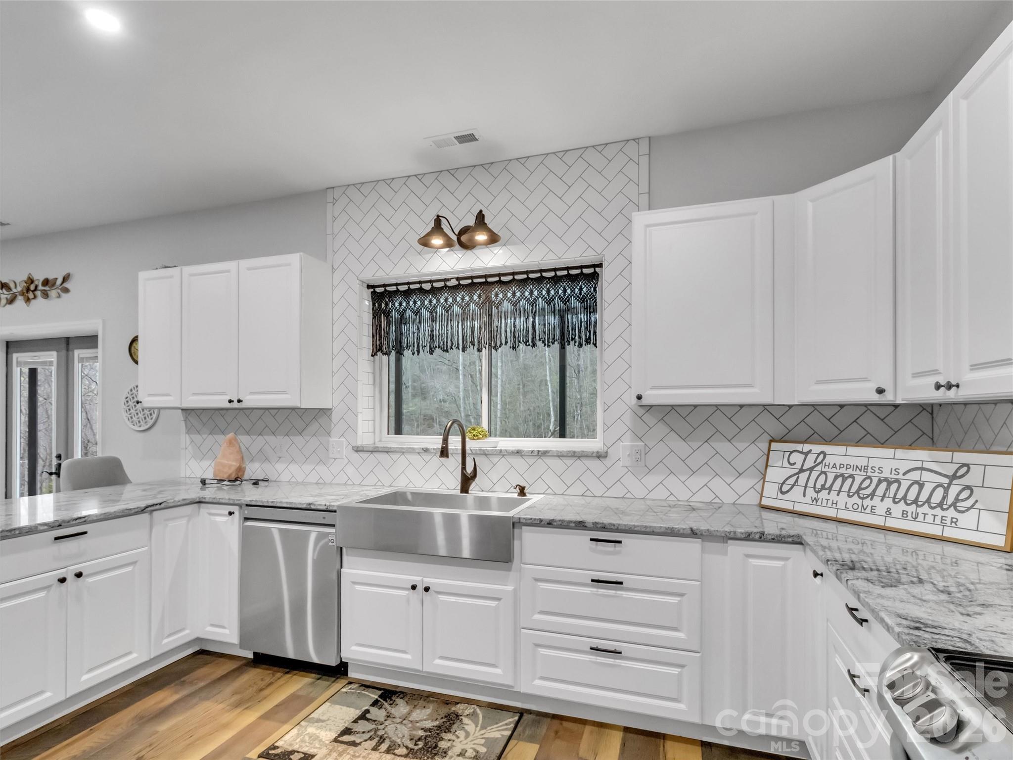 115 Fugitive Run Sylva, NC 28779 - Photo 29 of 47 a kitchen with granite countertop a sink and cabinets