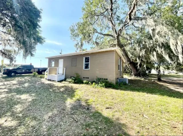a view of a room with gym equipment and a large window