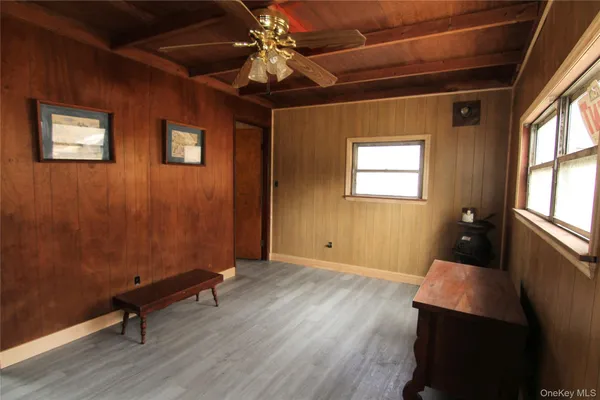 a view of a room with wooden floor and windows