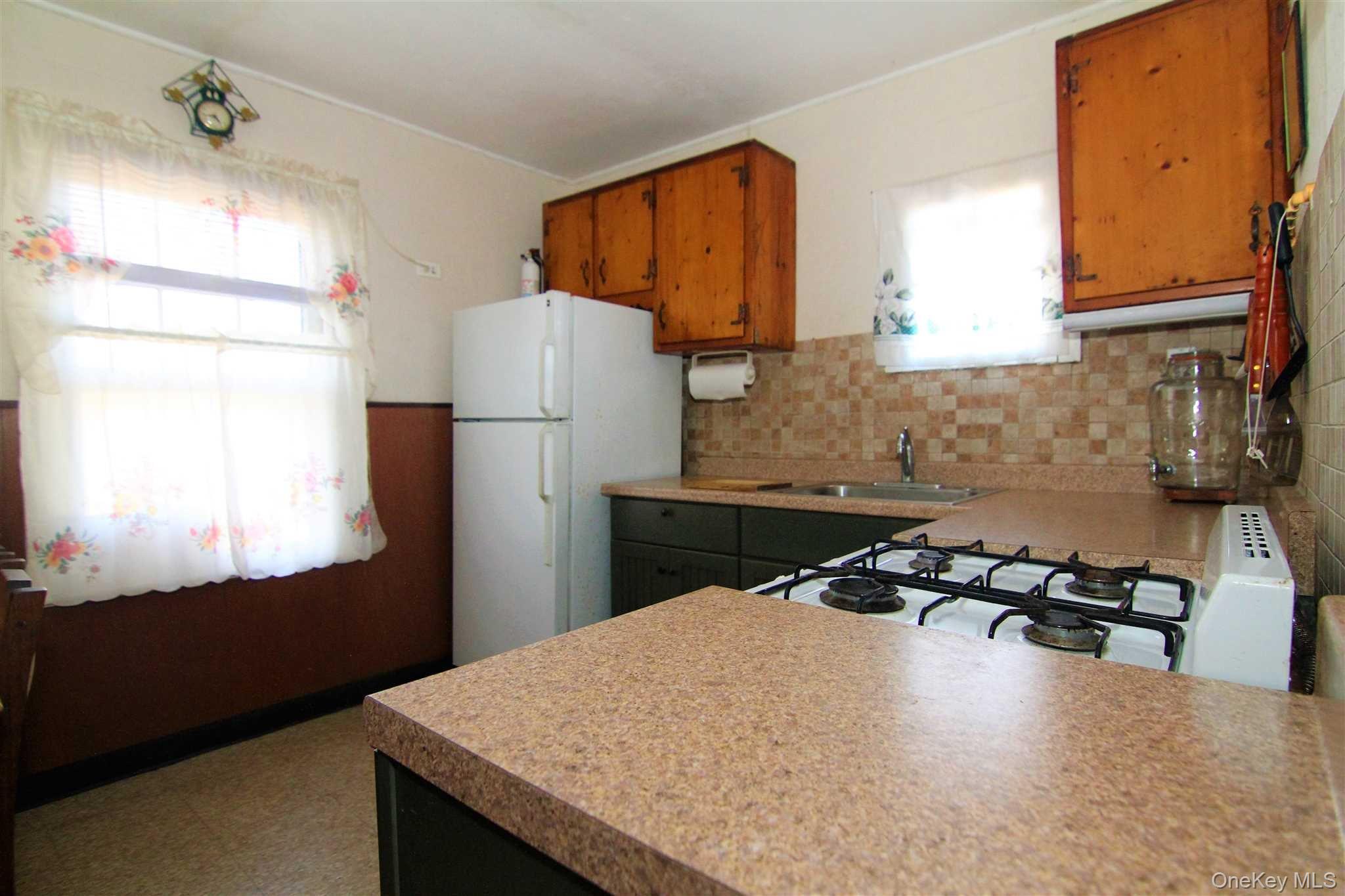 35 Glanhope Road, Unit 18 Hopewell Junction, NY 12533 - Photo 10 of 25 a kitchen with a refrigerator a stove a sink a counter top space and cabinets