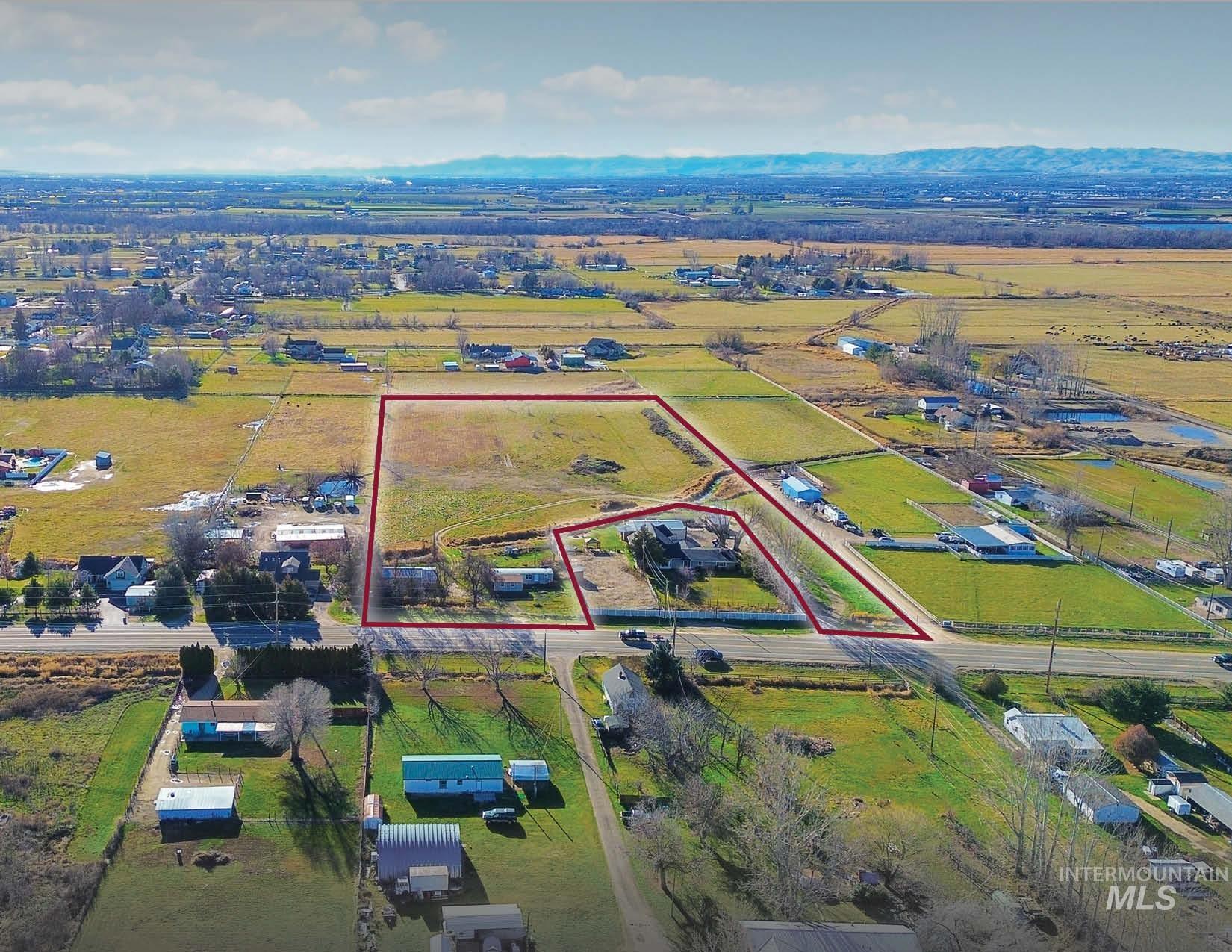 Aerial view of sparsely populated area featuring property boundaries highlighted