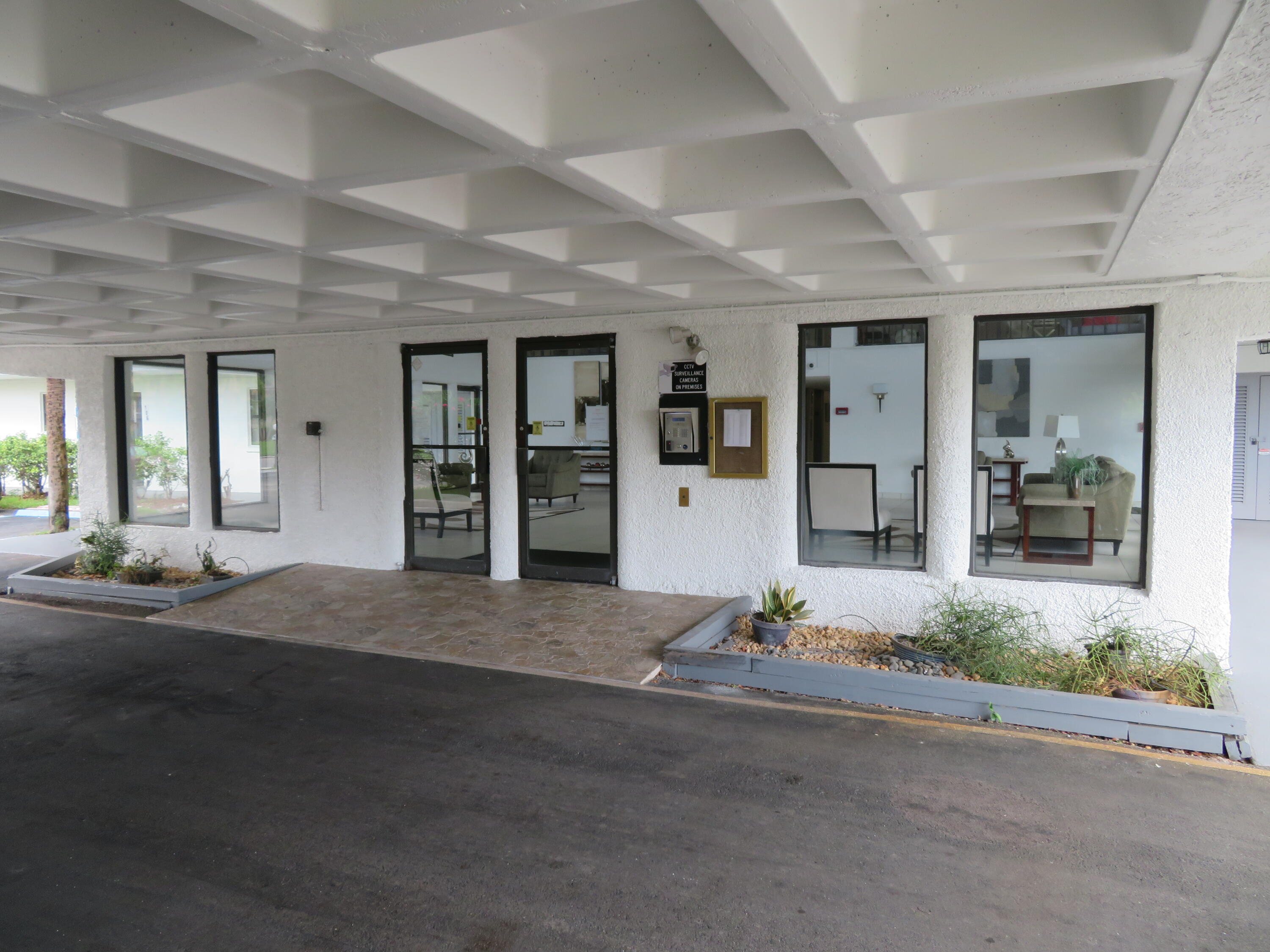 9233 Southwest 8th Street, Unit 117 Boca Raton, FL 33428 - Photo 5 of 37 8_9233_Bldg._Lobby_Entry