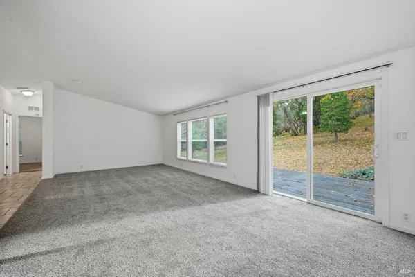 a view of an empty room with a balcony