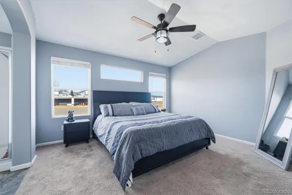 a bedroom with a large bed and a window
