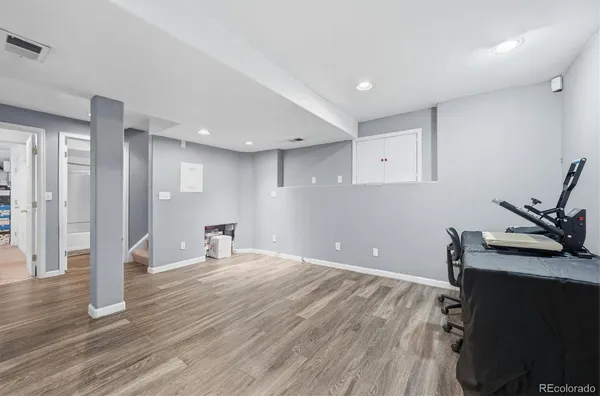 a room with wooden floor and white walls