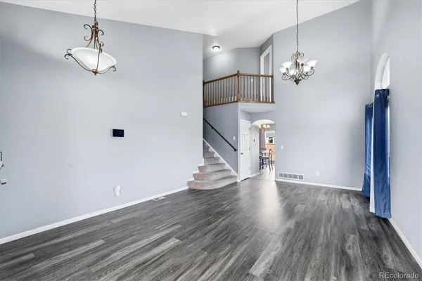 a view of a room with wooden floor and staircase