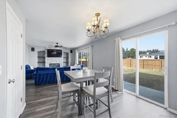 a view of a dining room with furniture wooden floor and chandelier