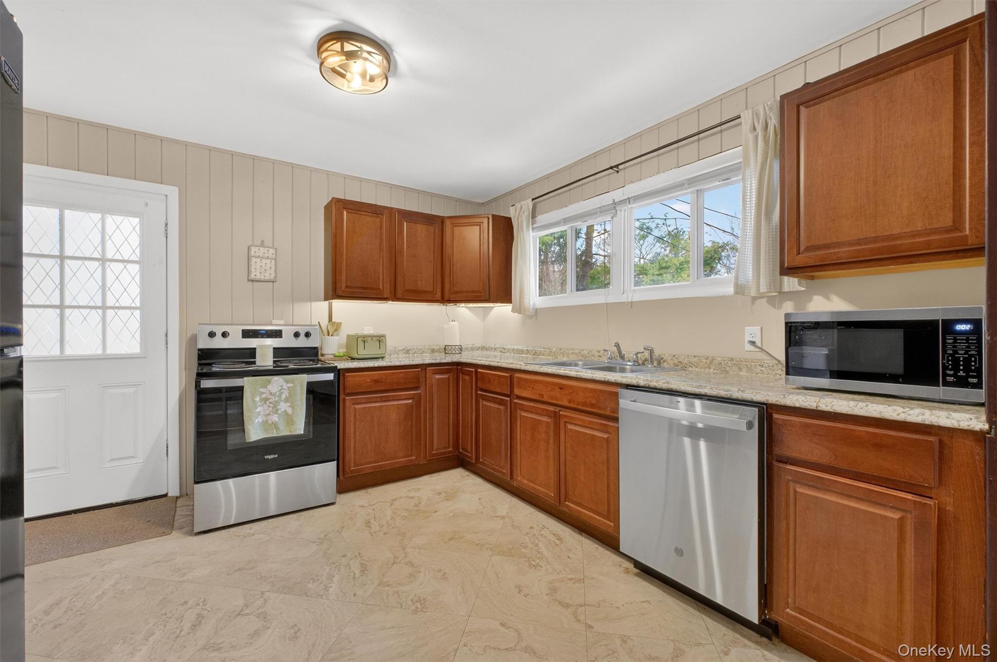 44 Legion Road Poughkeepsie, NY 12601 - Photo 2 of 28 a kitchen with granite countertop a stove top oven sink and cabinets