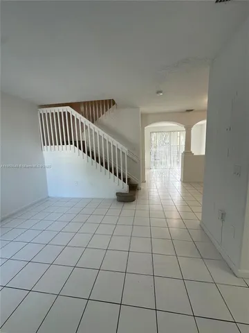 a view of staircase with white walls