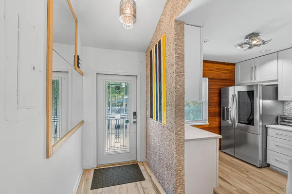 a large white kitchen with stainless steel appliances