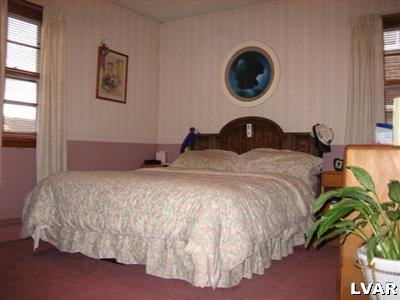 813 Spring Street Bethlehem, PA 18018 - Photo 6 of 12 a bedroom with a bed and a potted plant