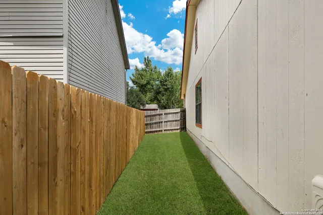 a view of a backyard with potted plants