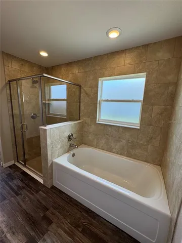 a bathroom with a bathtub and a shower