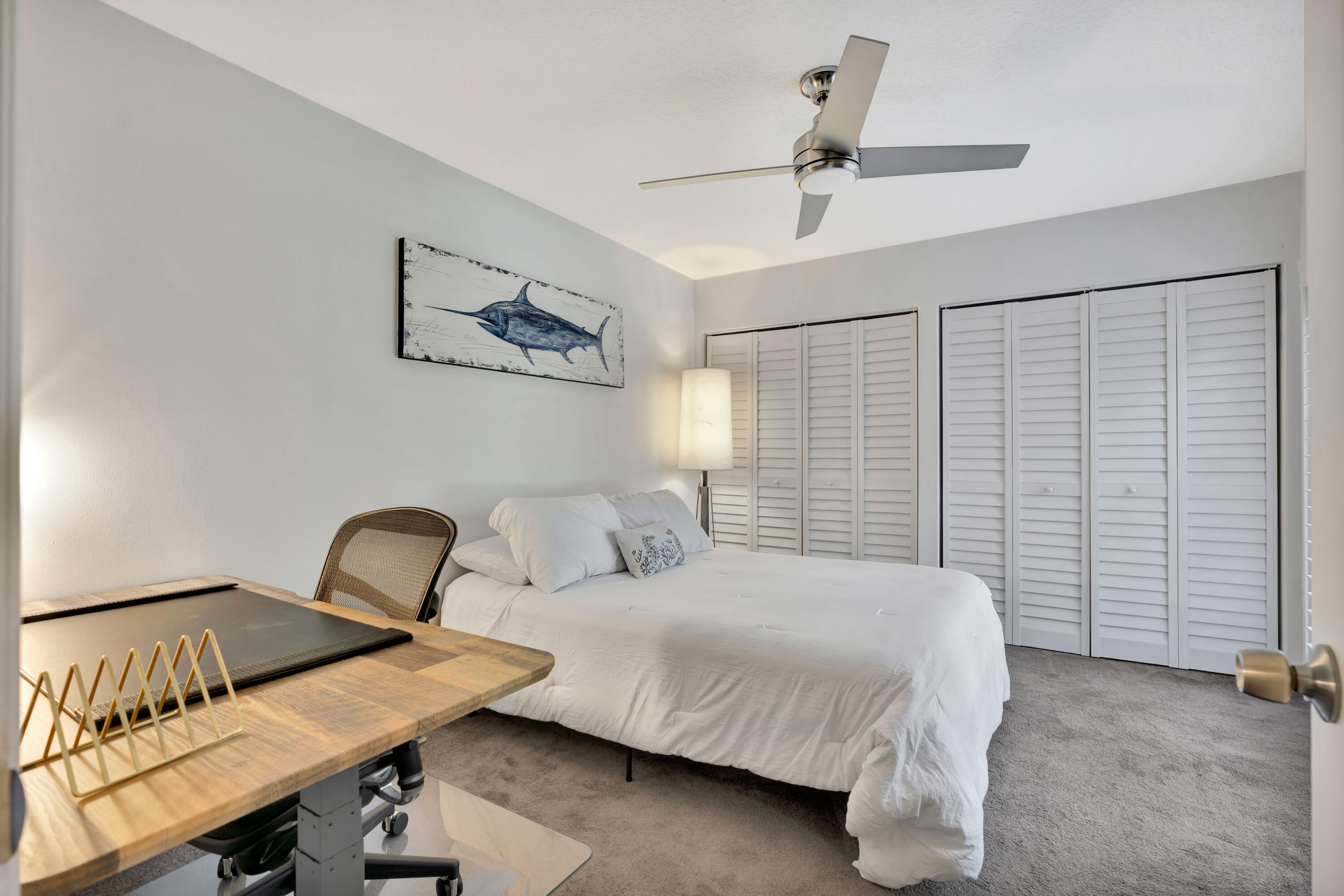 1209 12th Court Jupiter, FL 33477 - Photo 17 of 31 a bedroom with a bed and a table in it