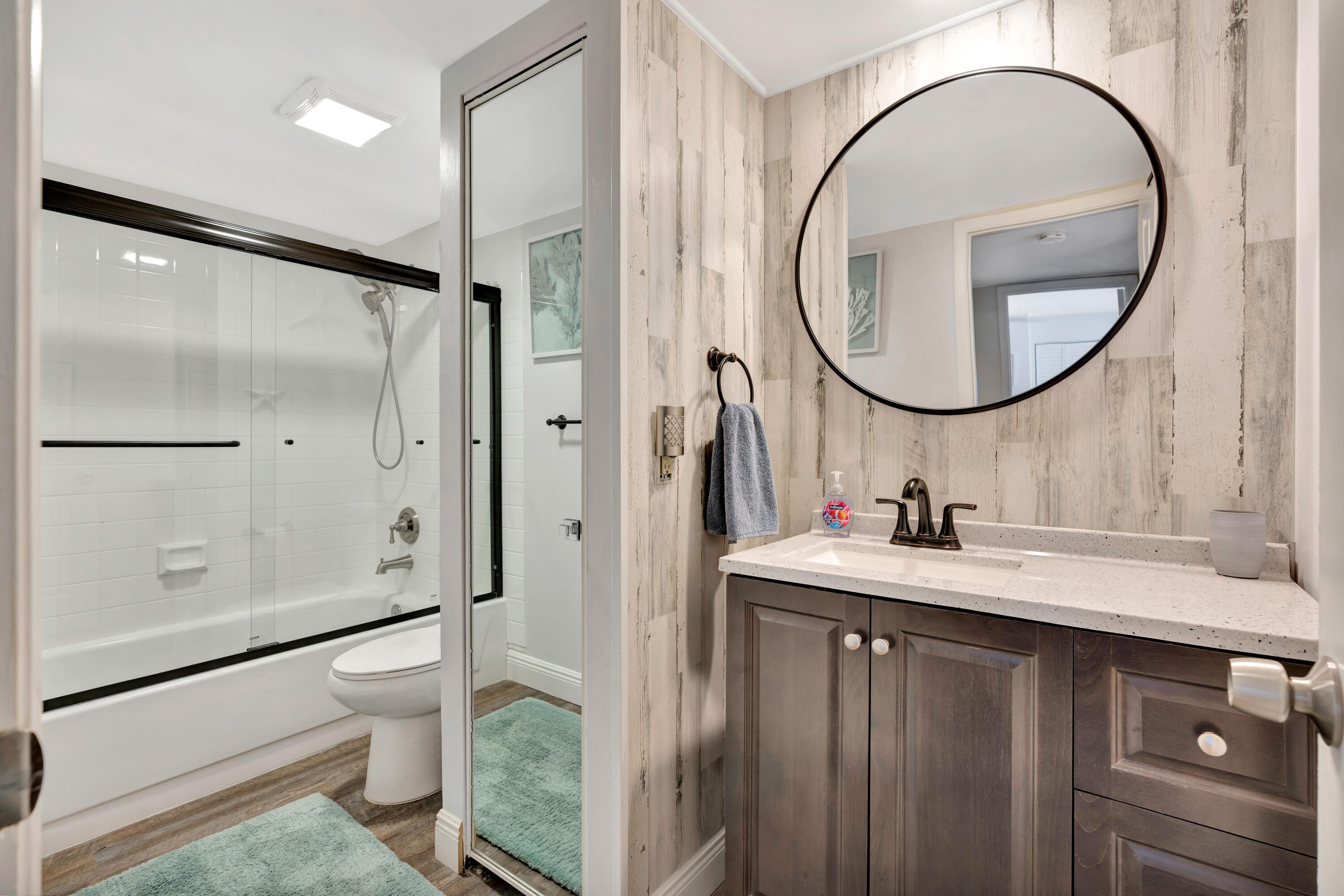 1209 12th Court Jupiter, FL 33477 - Photo 19 of 31 a bathroom with a sink a toilet and a mirror