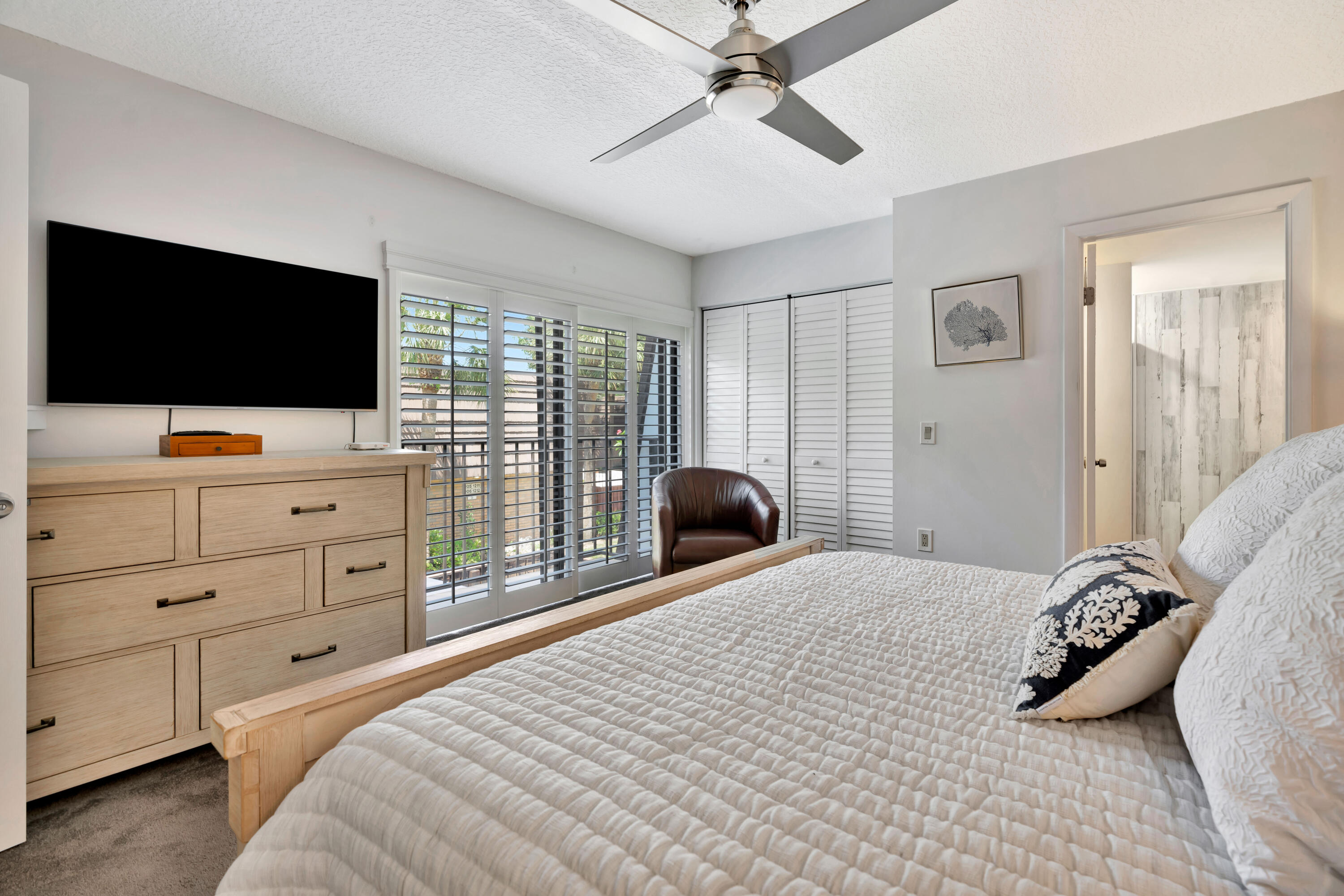 1209 12th Court Jupiter, FL 33477 - Photo 21 of 31 a bedroom with a bed and a flat screen tv