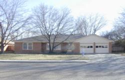 6015 Calumet Road Amarillo, TX 79106 - Photo 1 of 1 a front view of residential houses with yard and trees