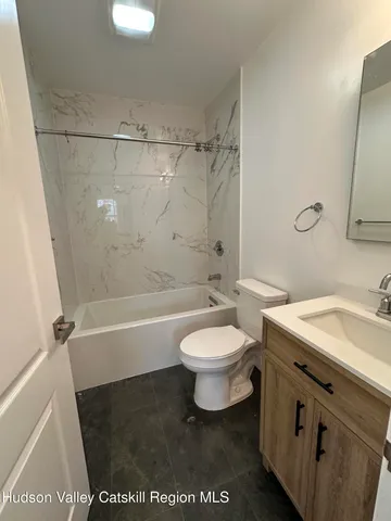 a bathroom with a toilet a sink and a bathtub