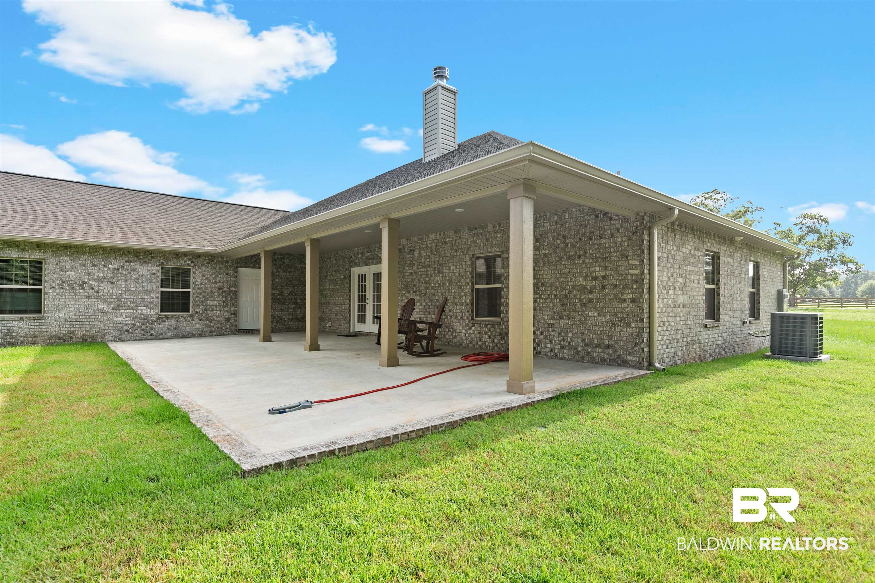 8552 March Road Irvington, AL 36544 - Photo 27 of 28 Expansive covered patio featuring a concrete surface, column supports, and double French doors