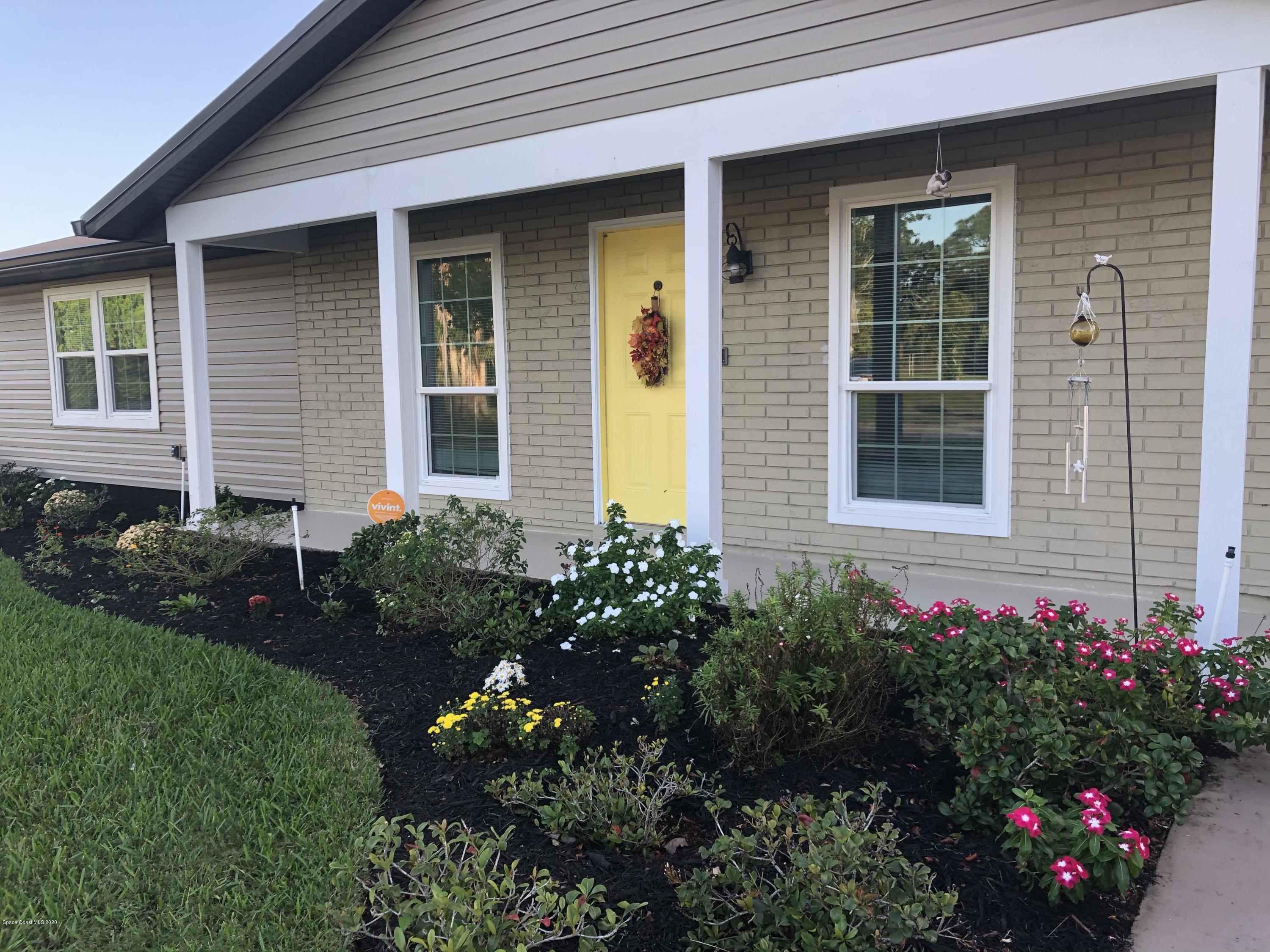 1491 Creel Road Northeast Palm Bay, FL 32905 - Photo 1 of 50 a view of a house with a flower garden