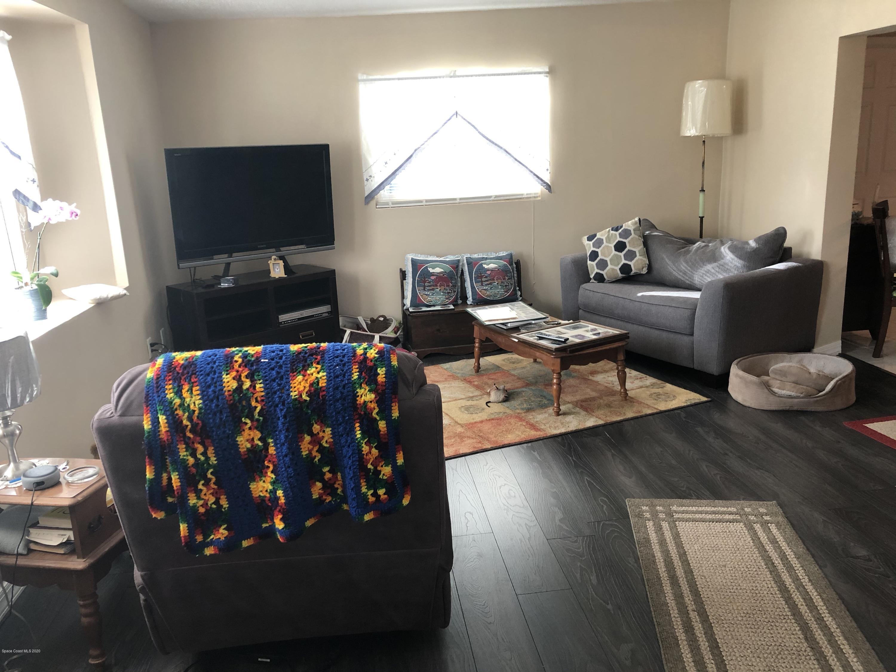 1491 Creel Road Northeast Palm Bay, FL 32905 - Photo 2 of 50 a living room with furniture and a flat screen tv