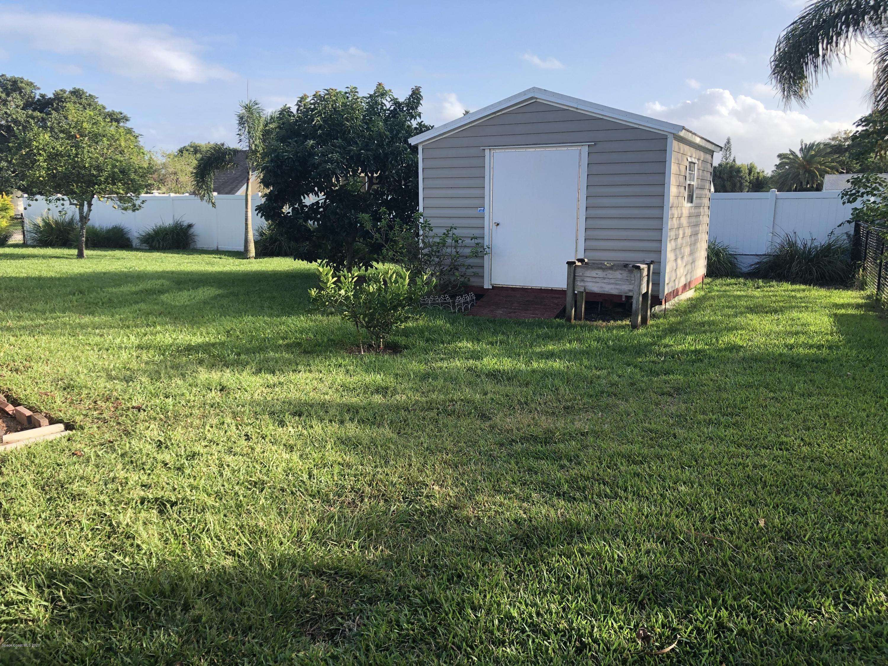1491 Creel Road Northeast Palm Bay, FL 32905 - Photo 11 of 50 a view of a house with a yard