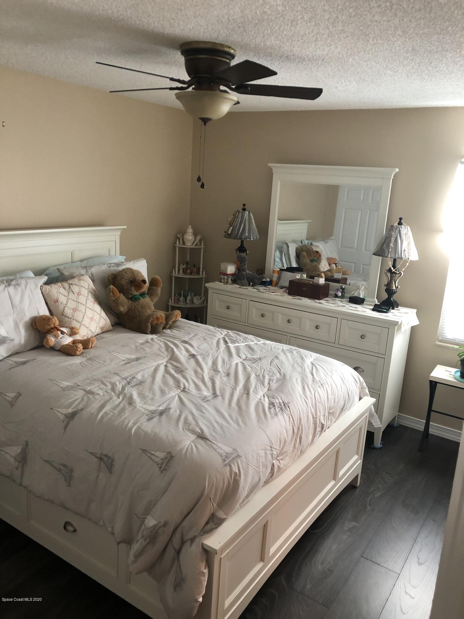 1491 Creel Road Northeast Palm Bay, FL 32905 - Photo 6 of 50 a bedroom with a bed and window