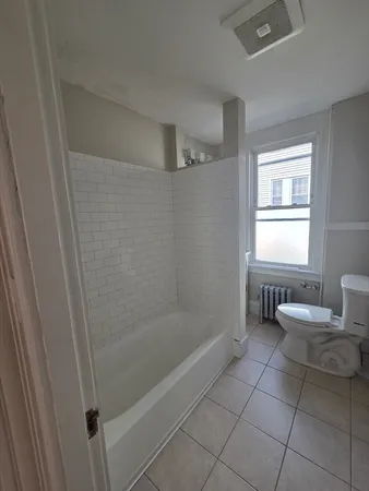 a bathroom with a bathtub and toilet