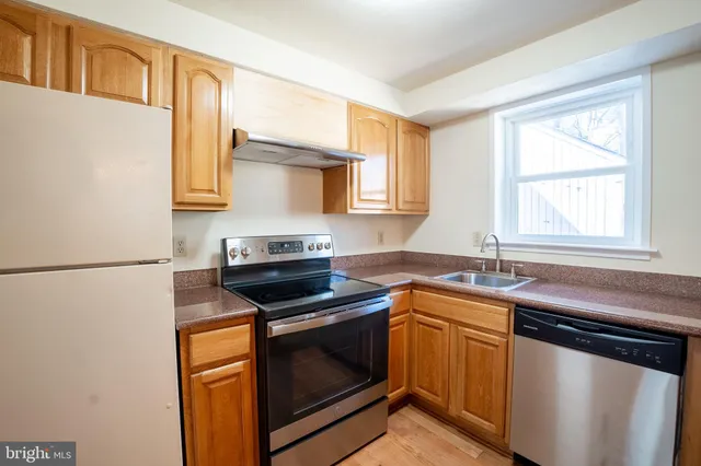 a kitchen with a sink stove and microwave