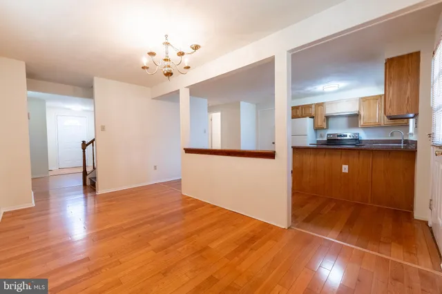 a view of a kitchen with a sink and a refrigerator