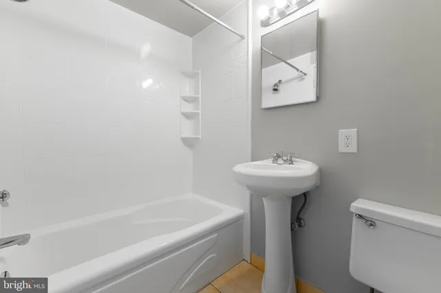 a bathroom with a sink a toilet and a bathtub