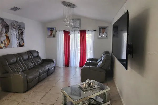 a living room with furniture and a chandelier