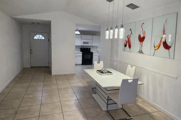 a view of kitchen with furniture and refrigerator