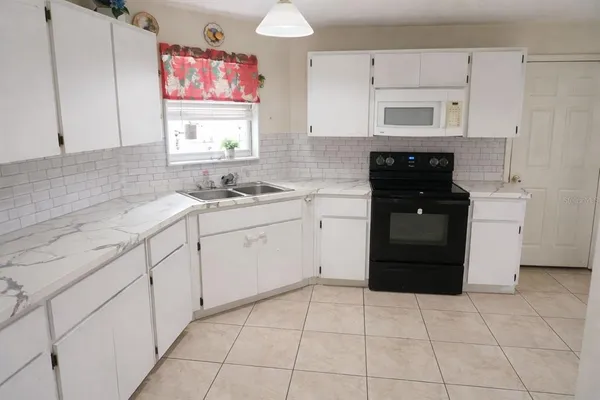 a kitchen with a cabinets and a stove top oven