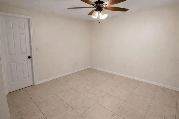 a bathroom with a granite countertop toilet a sink and a mirror