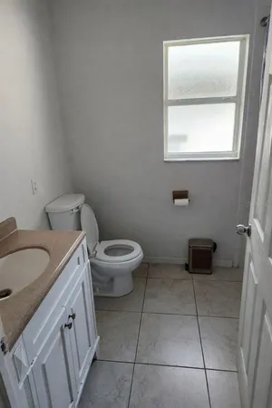 a view of a room with white tiles