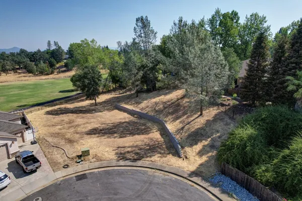 a view of a backyard with wooden fence