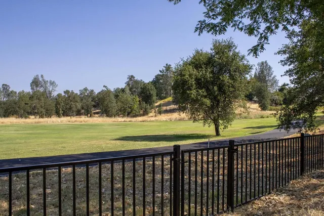 a view of a balcony with wooden floor and fence