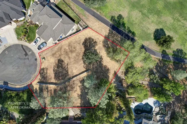 an aerial view of a house with garden space and street view