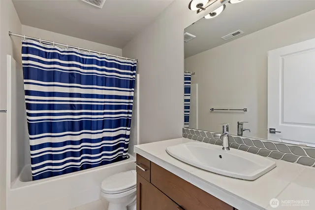 a bathroom with a sink toilet and mirror