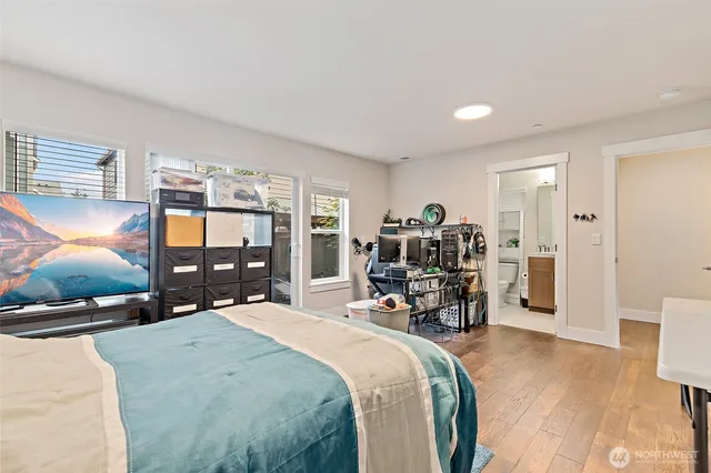 a bed room with a bed and a flat tv screen