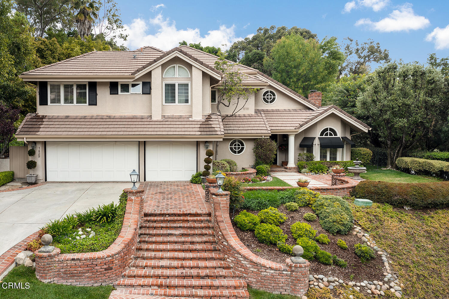 a front view of a house with garden and porch