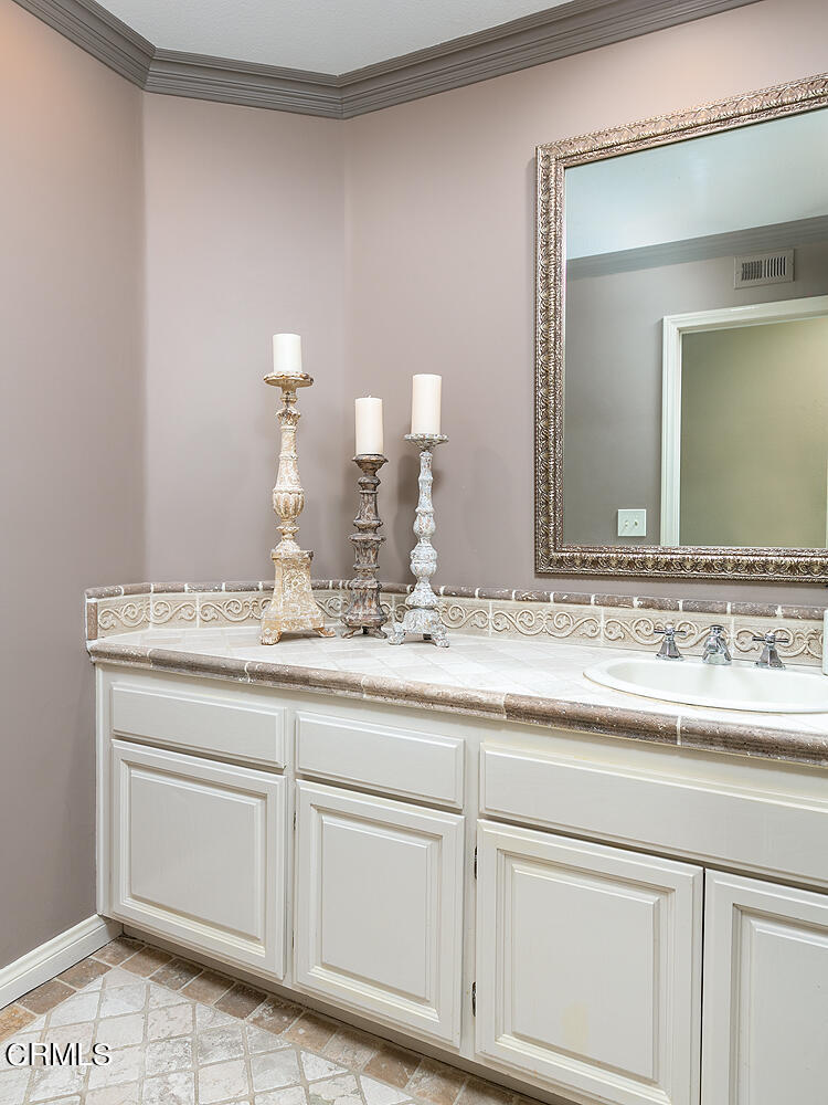 1429 Rutherford Drive Pasadena, CA 91103 - Photo 16 of 34 a bathroom with a sink and a mirror