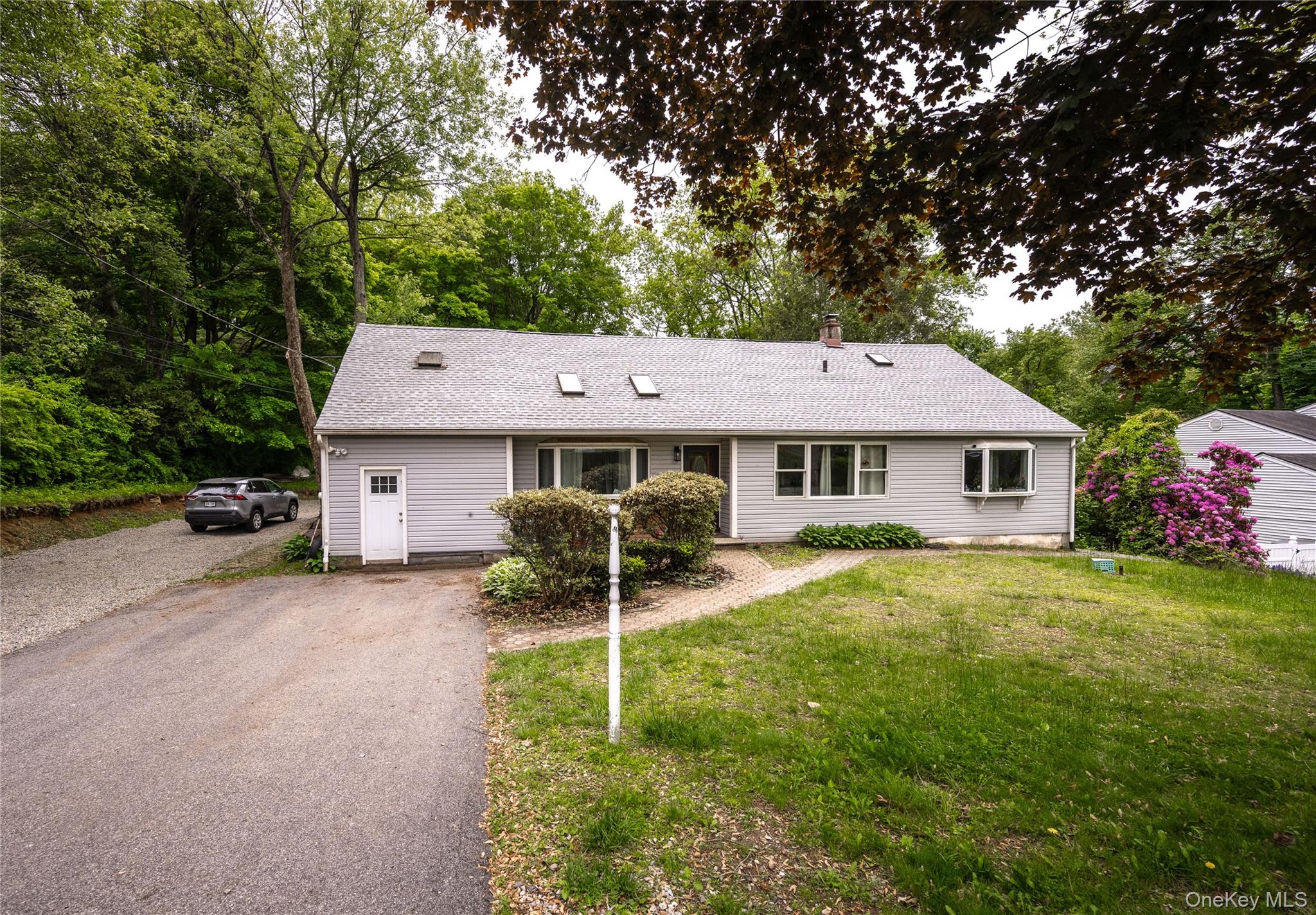 929 Fox Meadow Road Yorktown Heights, NY 10598 - Photo 36 of 39 Single story home featuring a front lawn, a chimney, a shingled roof, and asphalt driveway