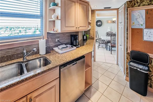 a kitchen with granite countertop a sink a stove and a microwave