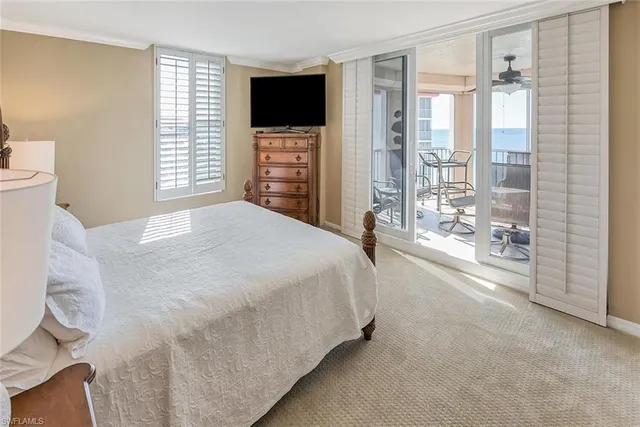 a spacious bedroom with a large bed and a flat screen tv